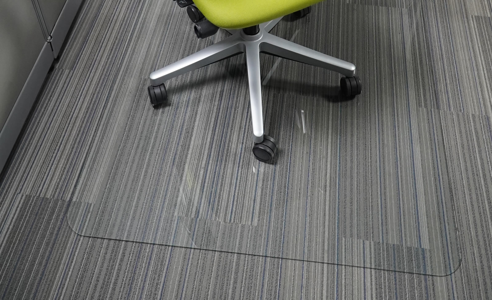 glass chair mat under green rolling office chair